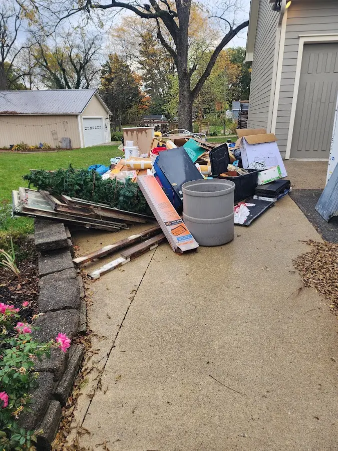 Dumpster being loaded with debris for Estate Cleanout Dumpster Rental in Logan
